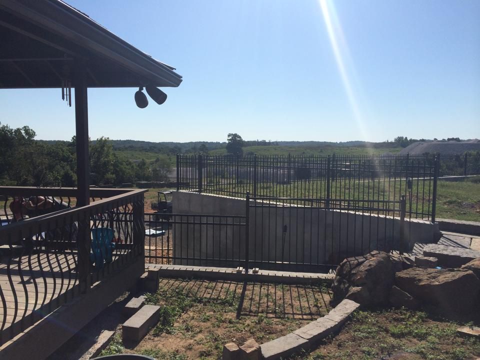 A view of a fenced in yard from a deck