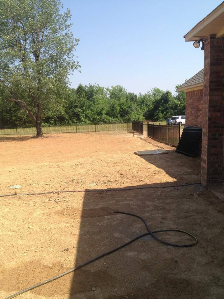 A hose is laying on the ground in front of a house