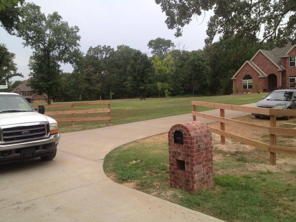 A white truck is parked in front of a brick mailbox