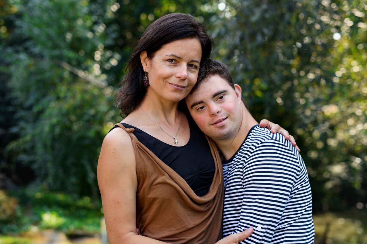 mother and son, trees in background