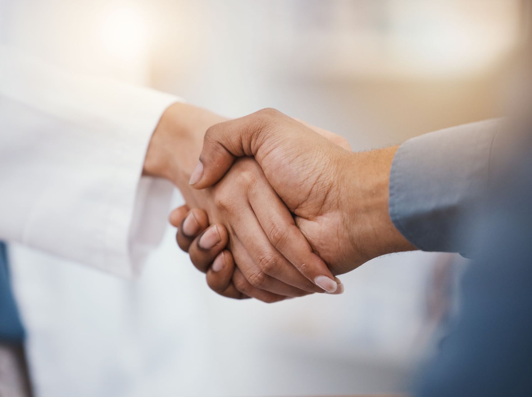 A close up of two people shaking hands.