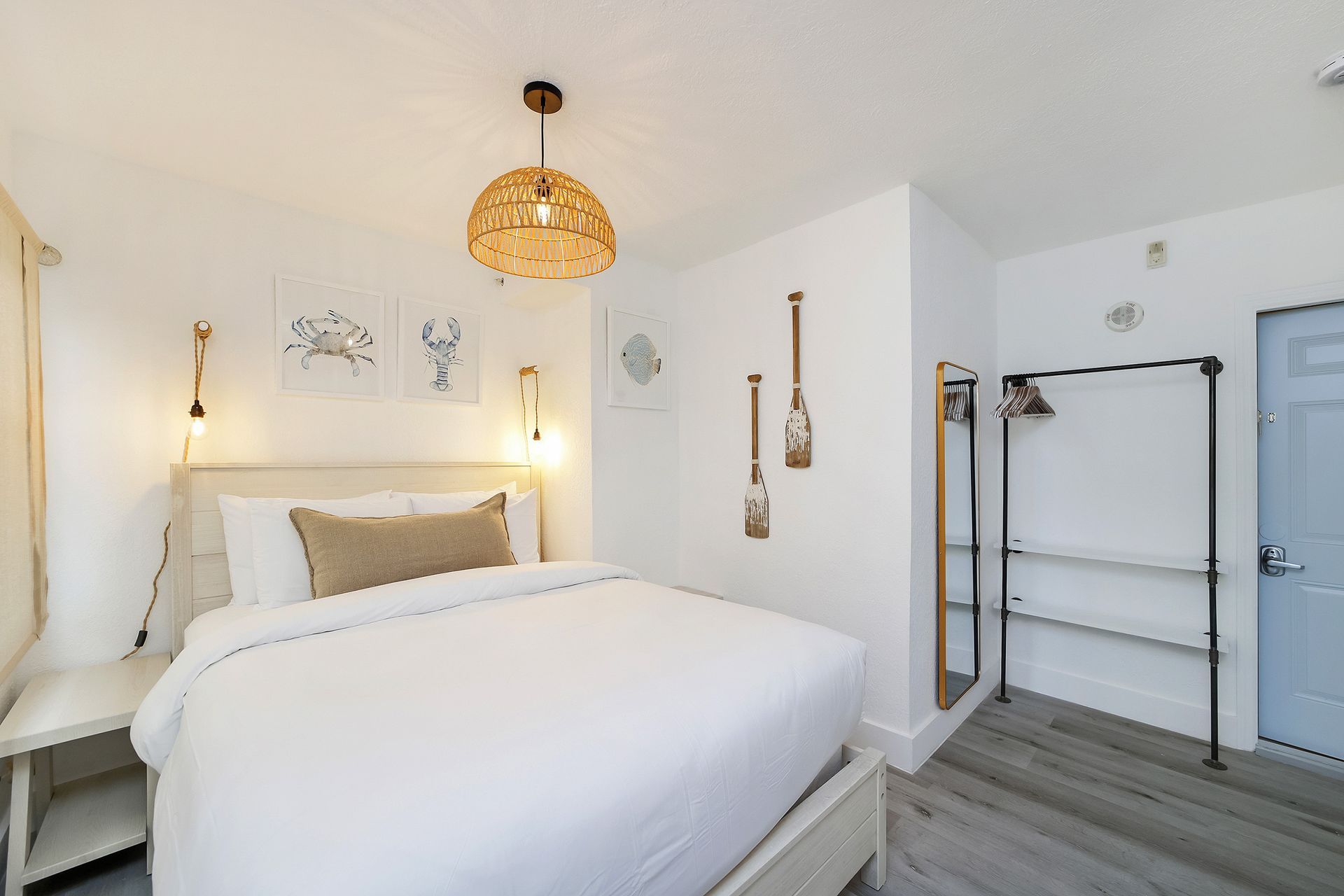 Bedroom with white walls, a bed, and nautical decor.