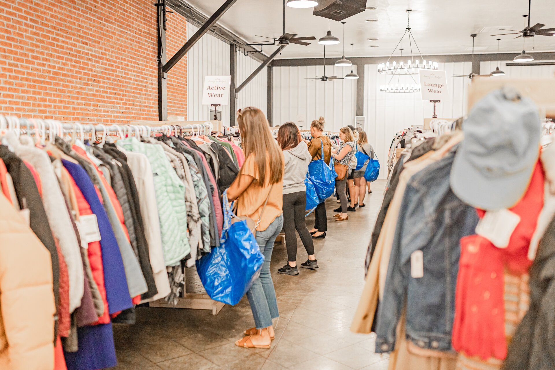 A group of people are shopping in a thrift store.