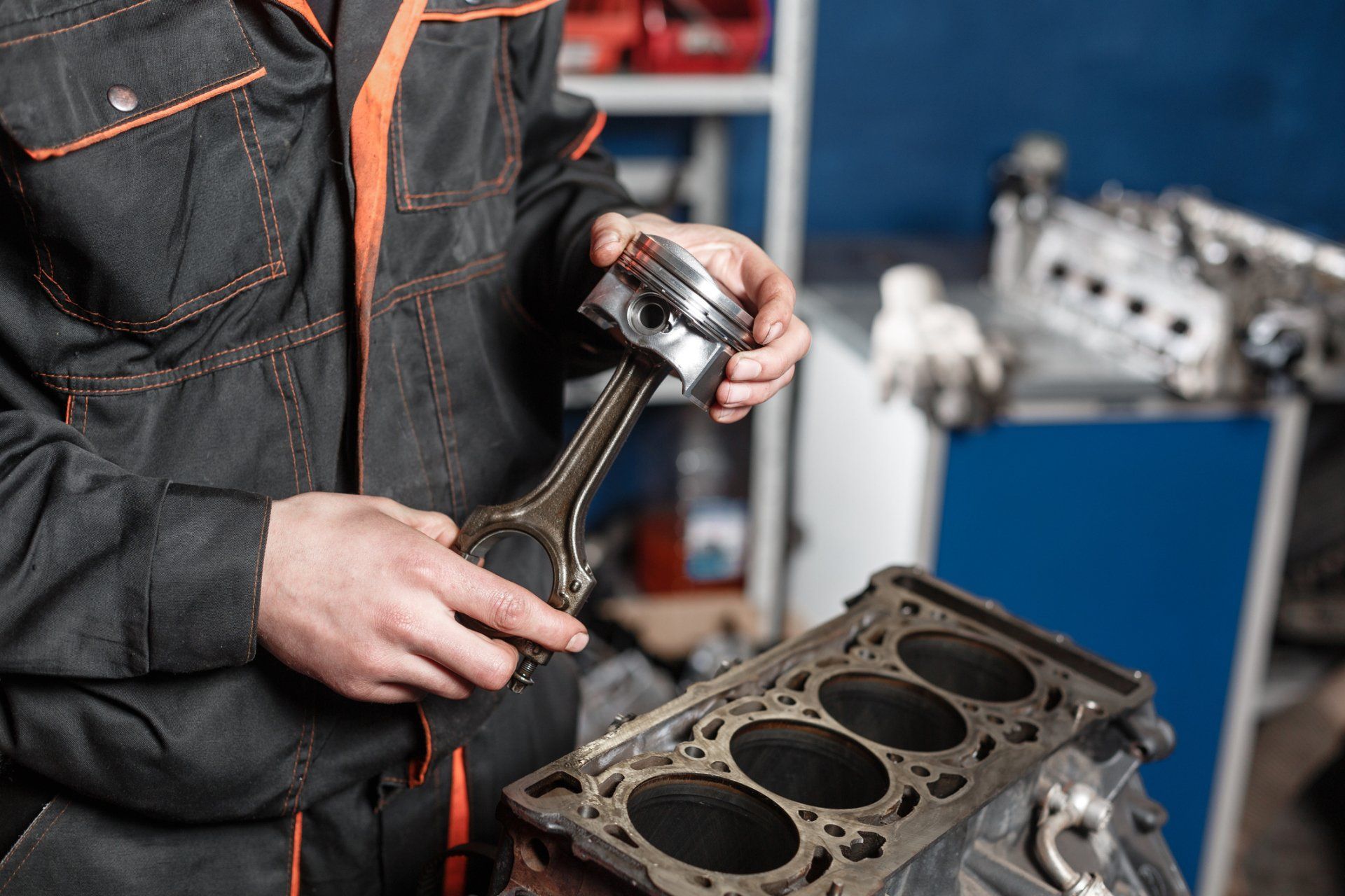 car mechanic holding a piston