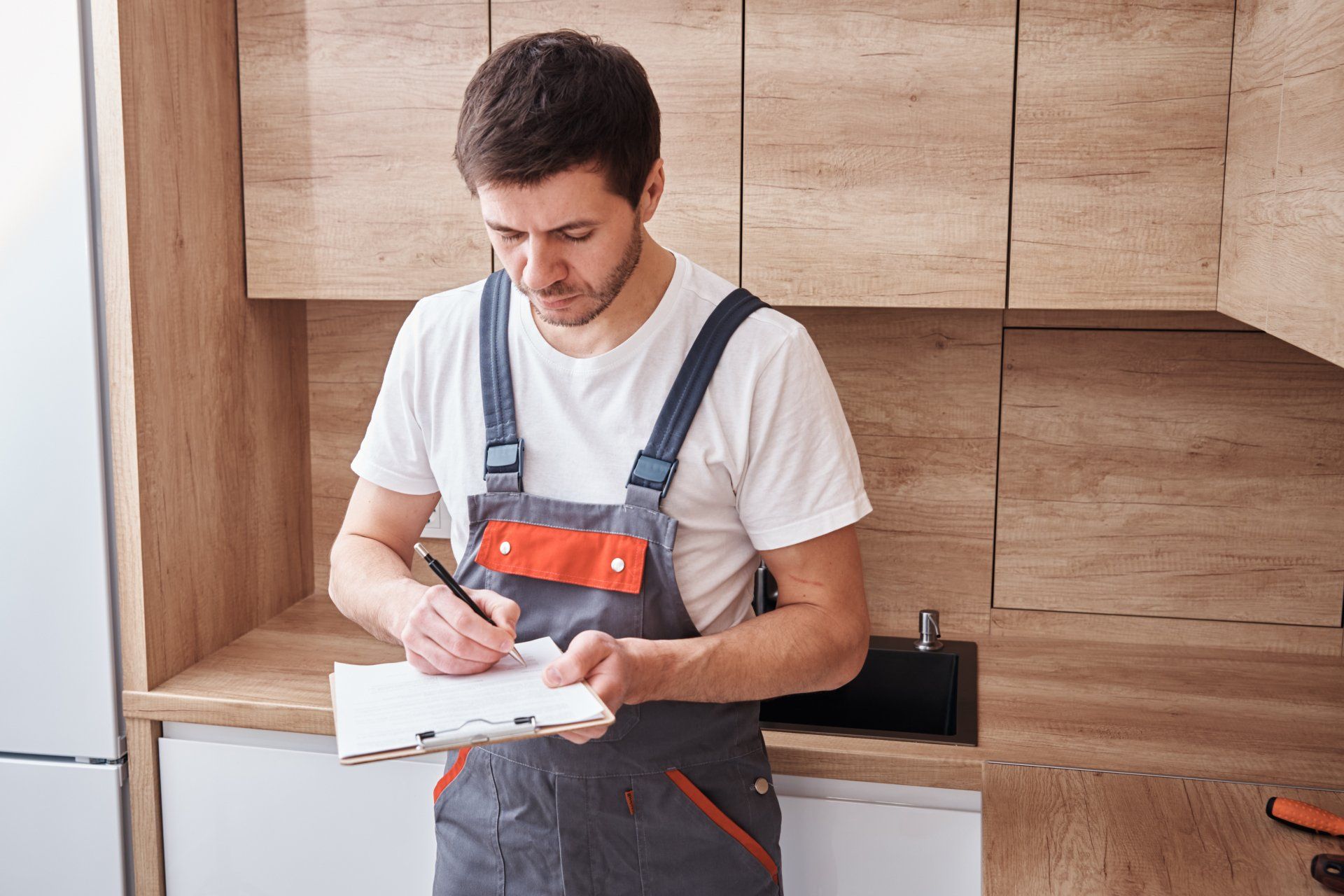 contractor writing on clipboard