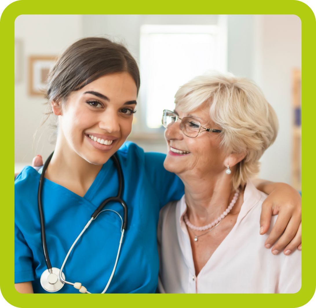 A nurse and an older woman are posing for a picture.