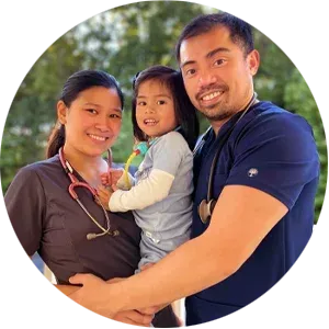 A man and woman holding a little girl in a circle