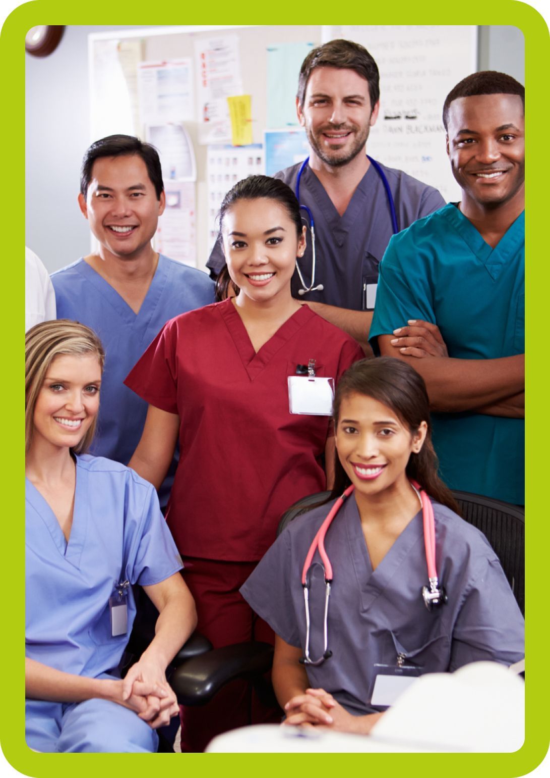 A group of doctors and nurses are posing for a picture in a hospital room.