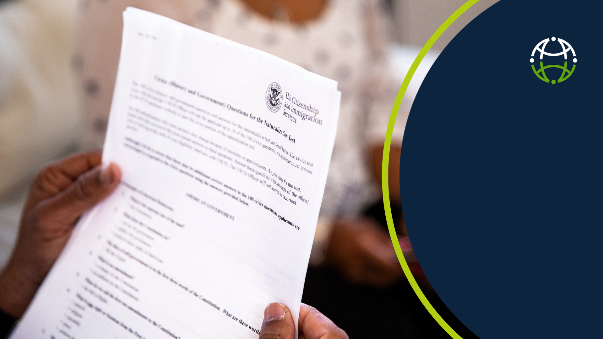 A pair of hands holding an official USCIS document