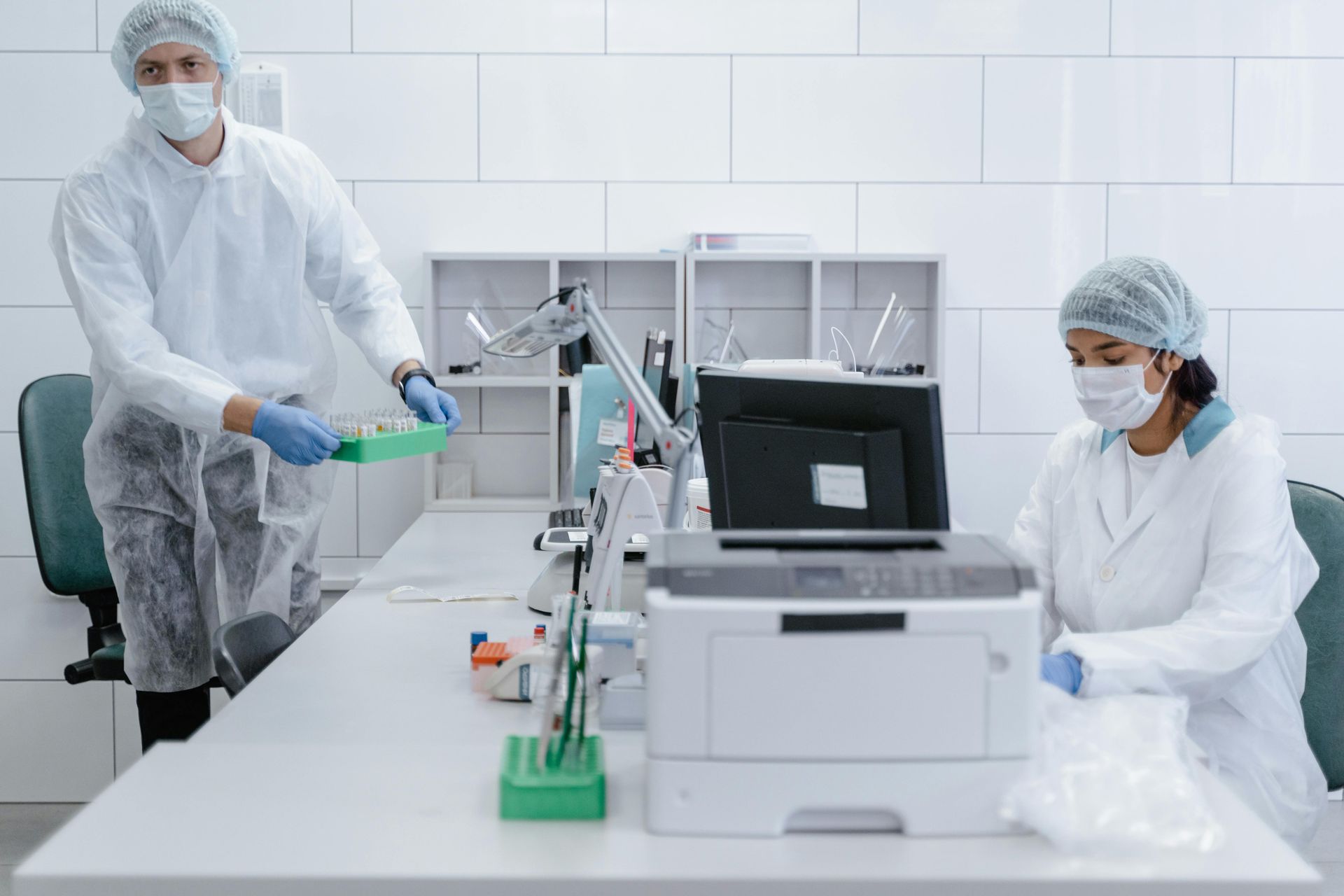 A man and a woman are working in a laboratory.