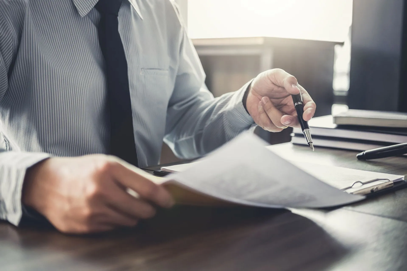 Person holding a pen and paper.