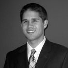 A man in a suit and tie smiles for the camera