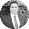 A man in a suit and tie is standing in a circle.