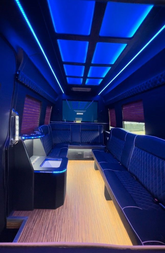 The inside of a limousine with blue lights on the ceiling
