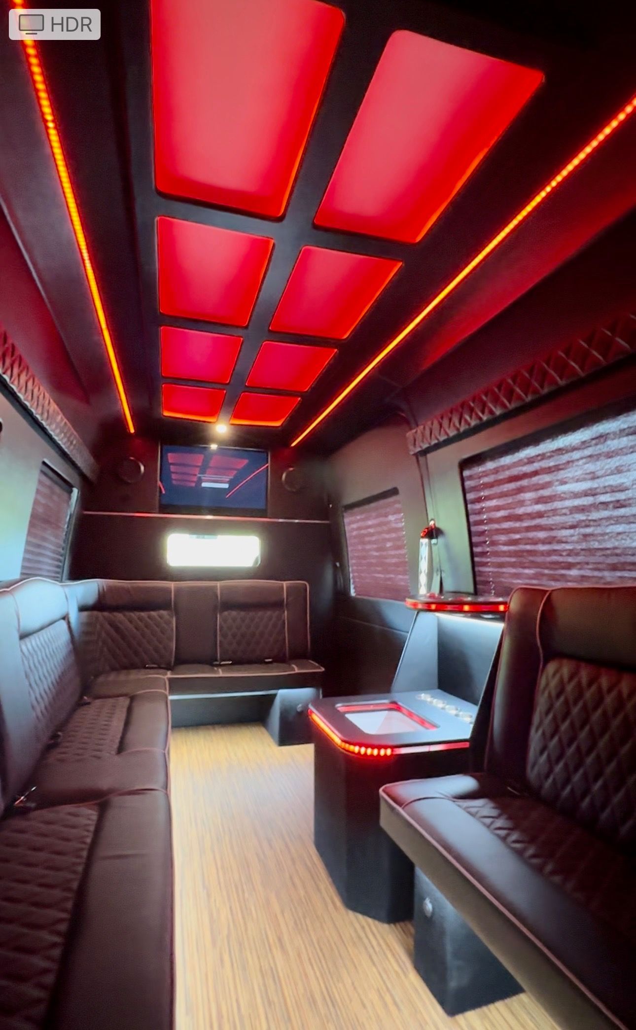 The inside of a bus with red lights on the ceiling