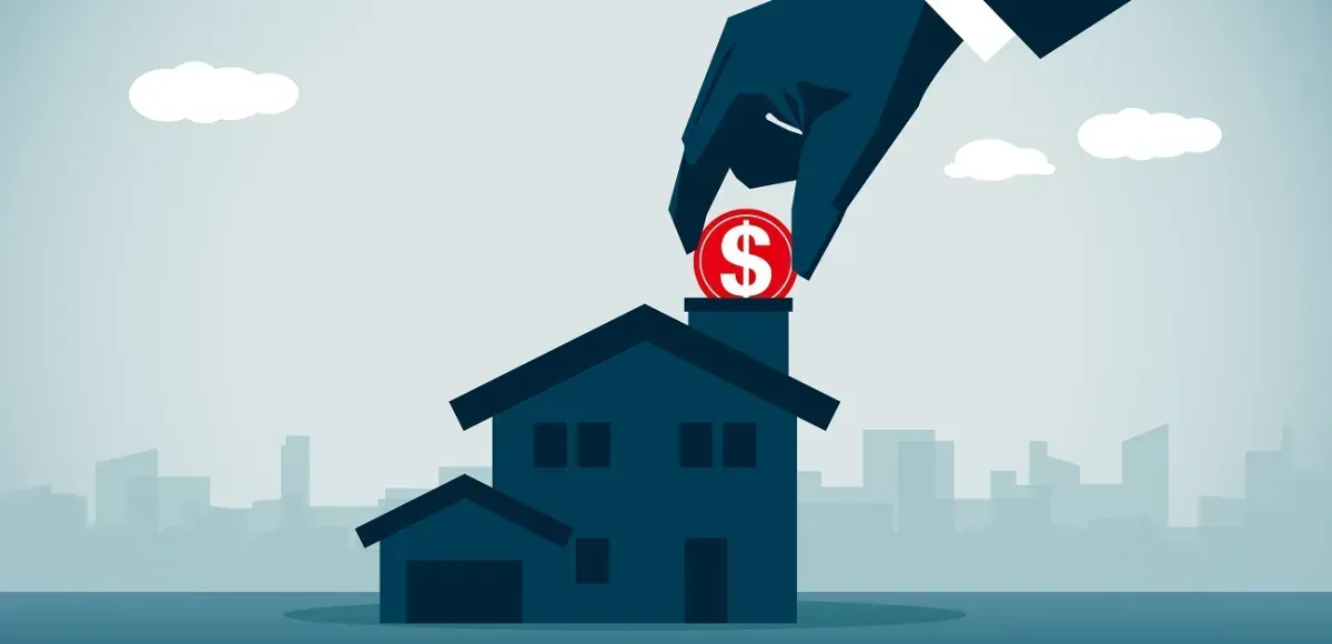 A hand is putting a dollar sign in the chimney of a house.