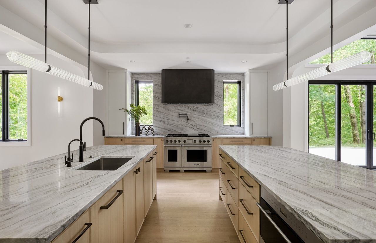 A kitchen with a stove , sink , and dishwasher.