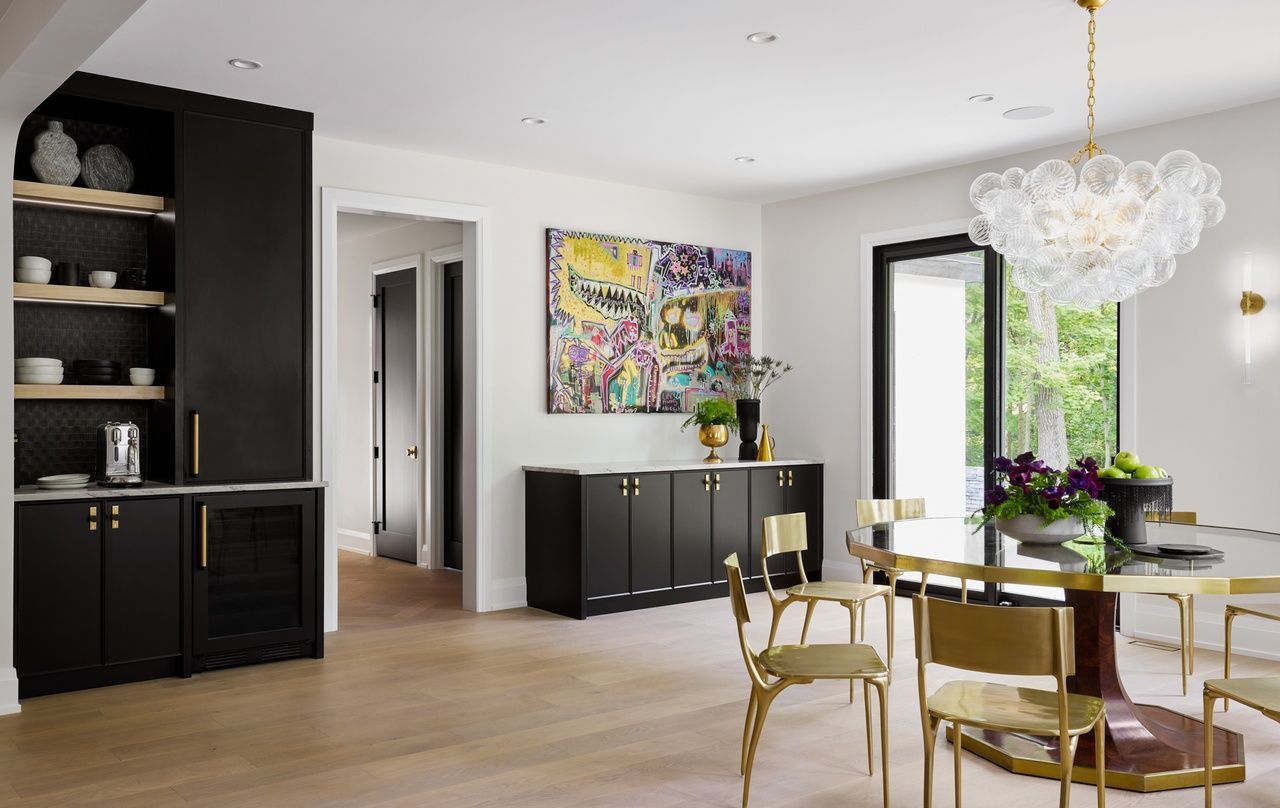 A dining room with a table and chairs and a chandelier.