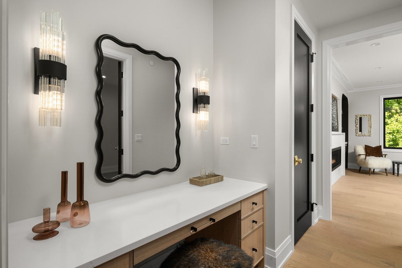 There is a vanity with a mirror on the wall.