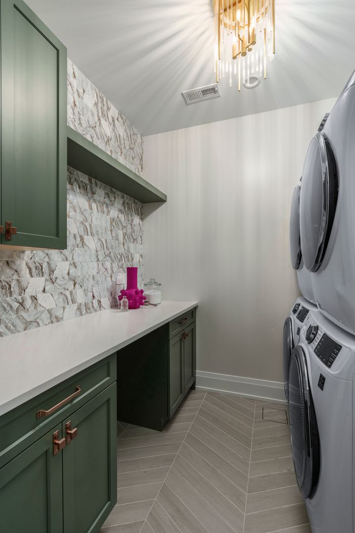 A laundry room with a washer and dryer stacked on top of each other.