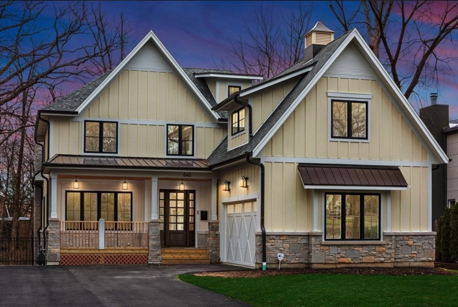 A large house with a lot of windows and a garage