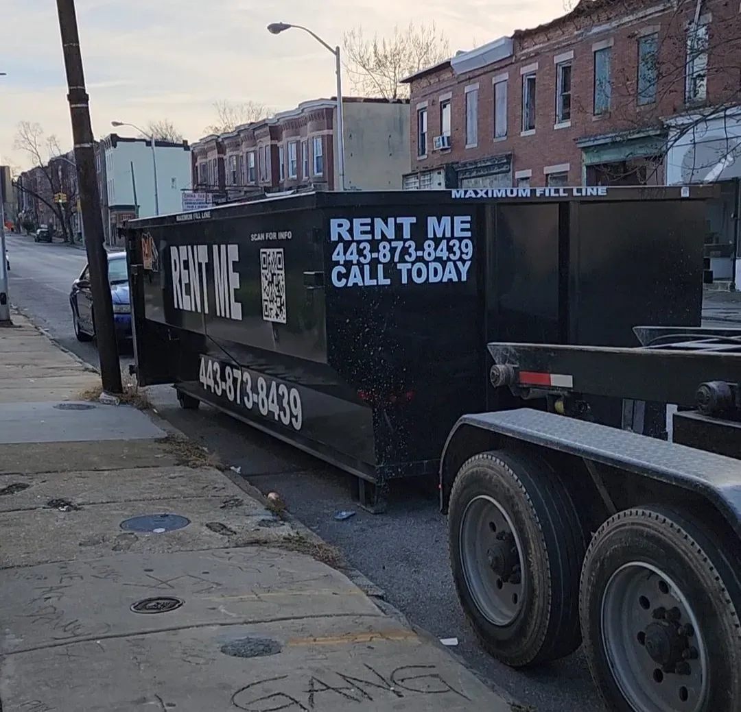 a 10 yard dumpster with a concrete slab in it is sitting on the side of the road .