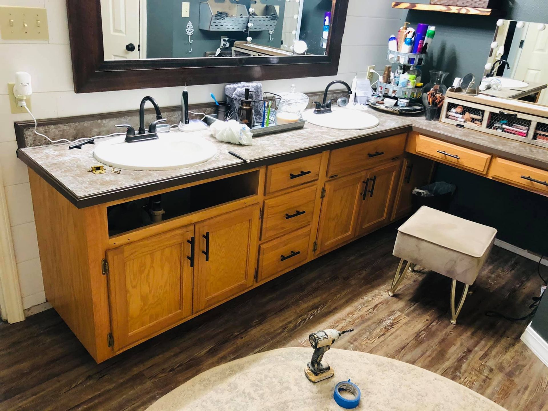 A bathroom with two sinks and a mirror.