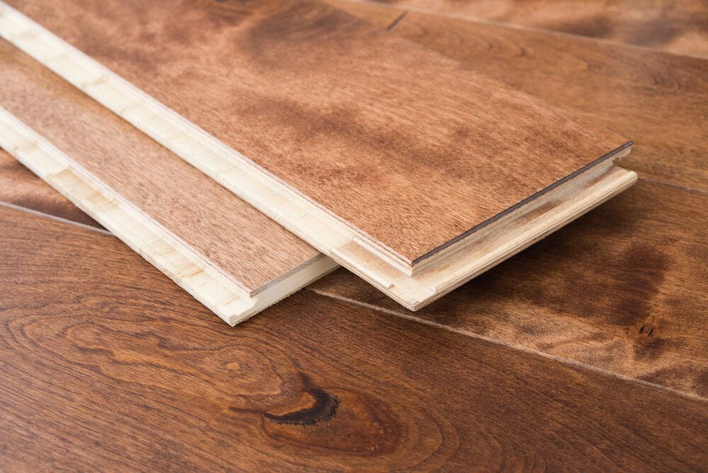 Two Pieces of Wood Are Stacked on Top of Each Other on a Wooden Floor — Shane Callinan Floor Sanding In North Haven, NSW