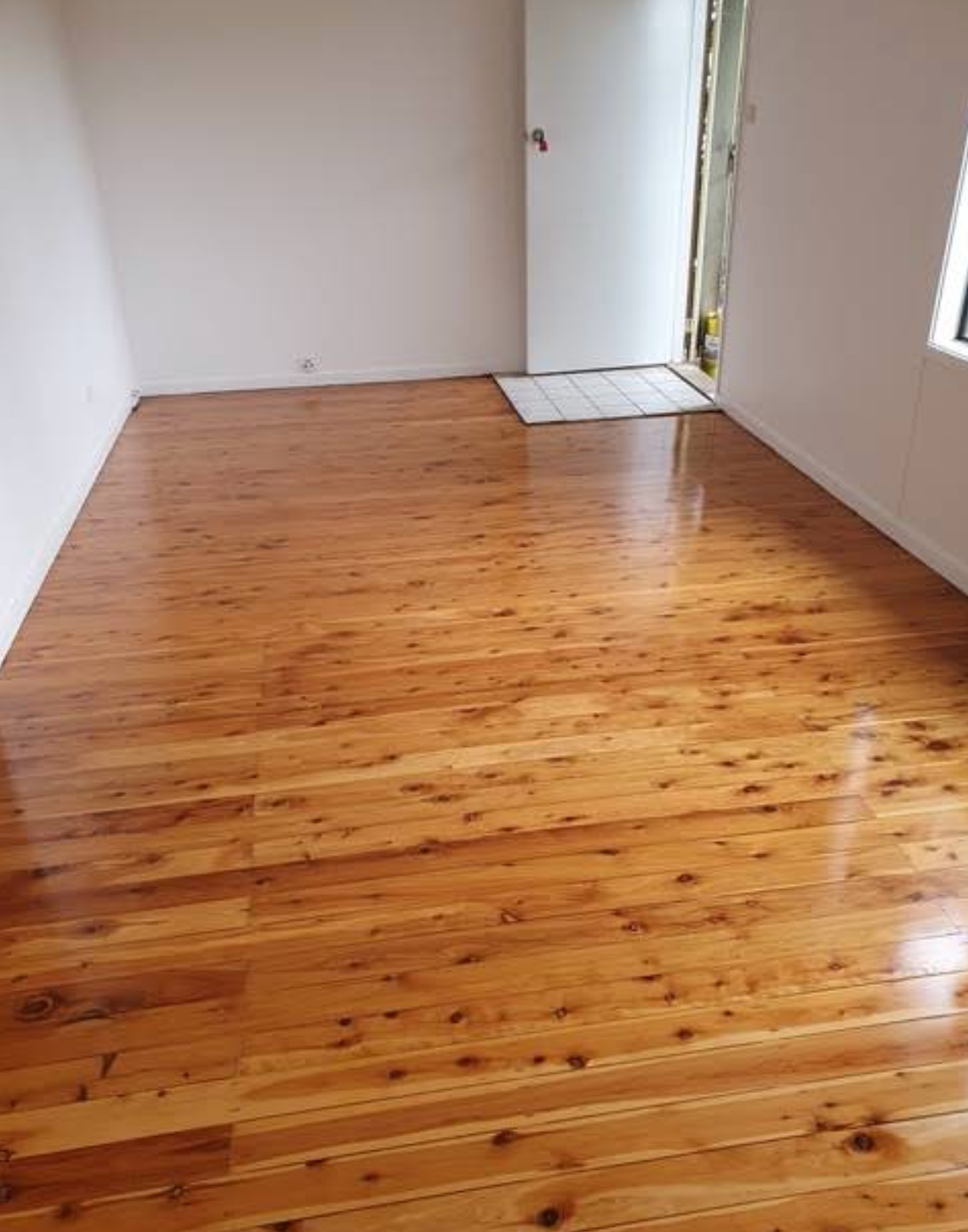 A Wooden Floor With a Herringbone Pattern in a Living Room — Shane Callinan Floor Sanding In Bonny Hills, NSW