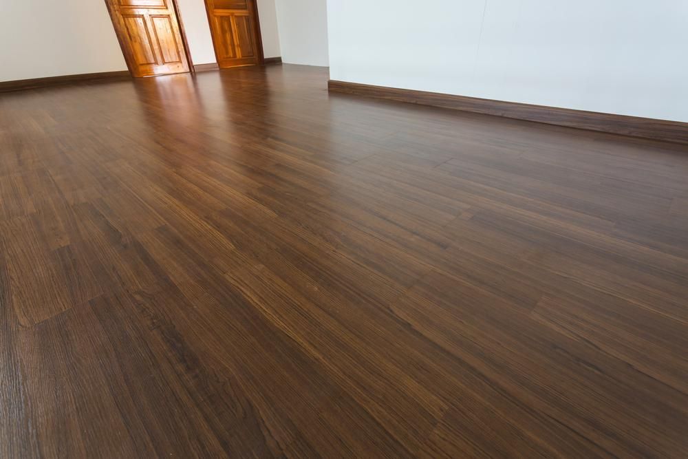 An Empty Room With a Wooden Floor and White Walls — Shane Callinan Floor Sanding In North Haven, NSW
