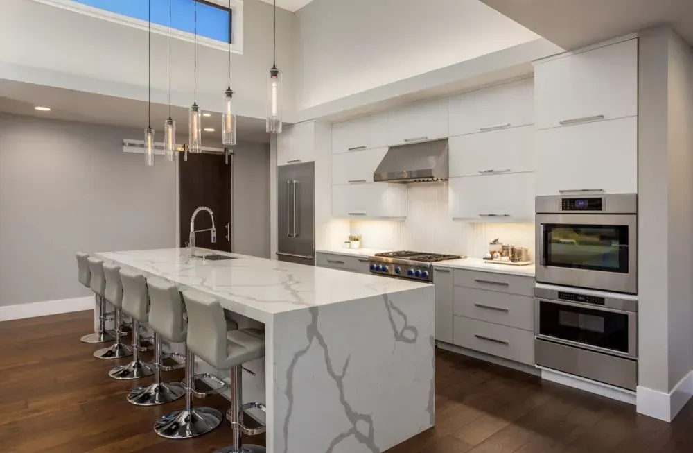 A Kitchen With Stainless Steel Appliances and a Large Island — Shane Callinan Floor Sanding In Bonny Hills, NSW