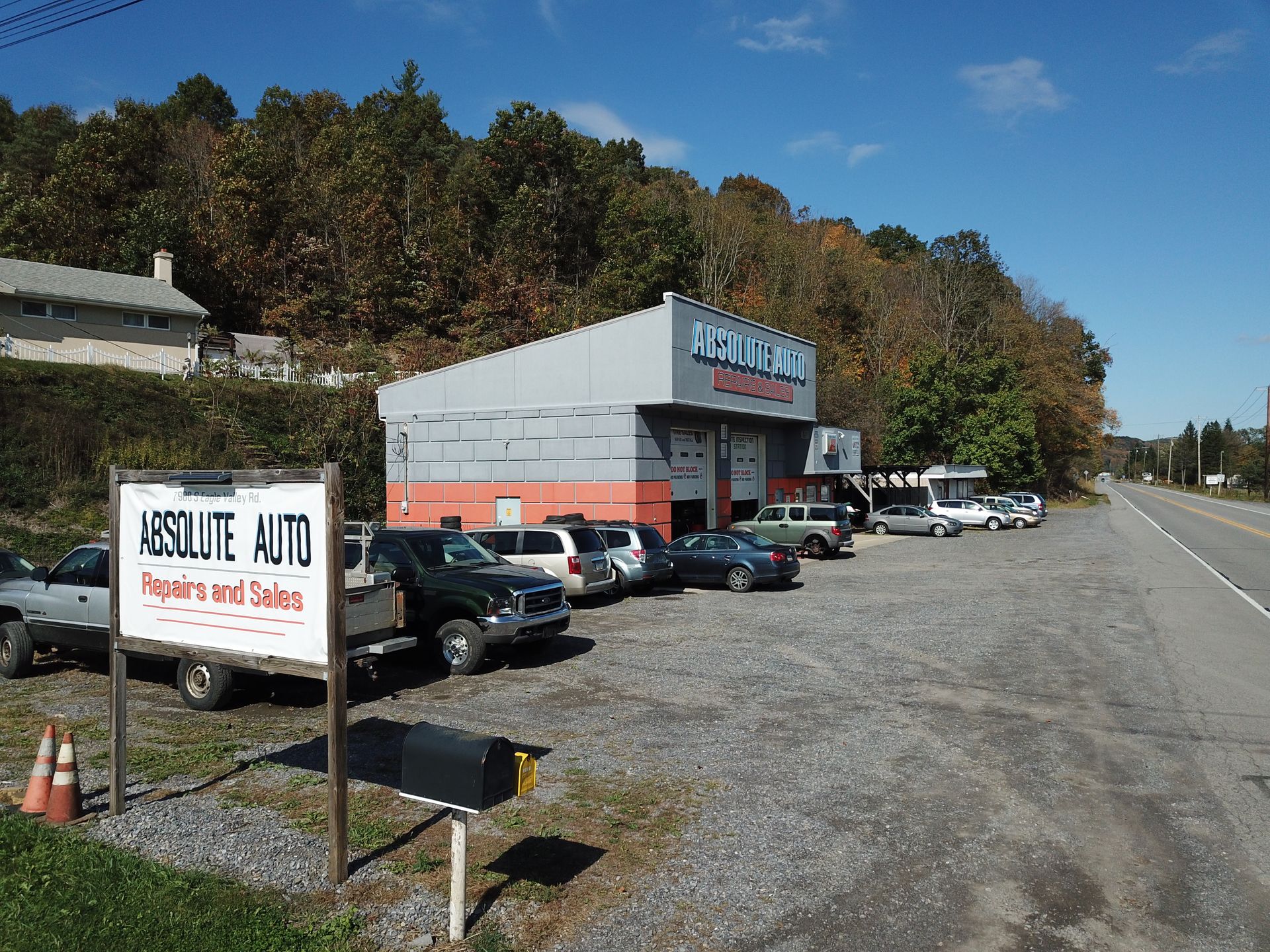 Absolute Auto shop with vehicles parked in front, sign visible, roadside setting. | Absolute Auto Repairs & Sales