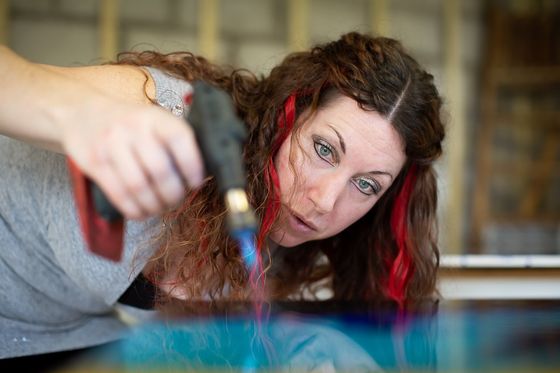 Celia Lancaster creating resin art in her studio