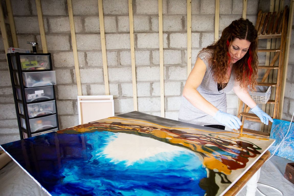 Celia Lancaster creating a large resin artwork in her studio