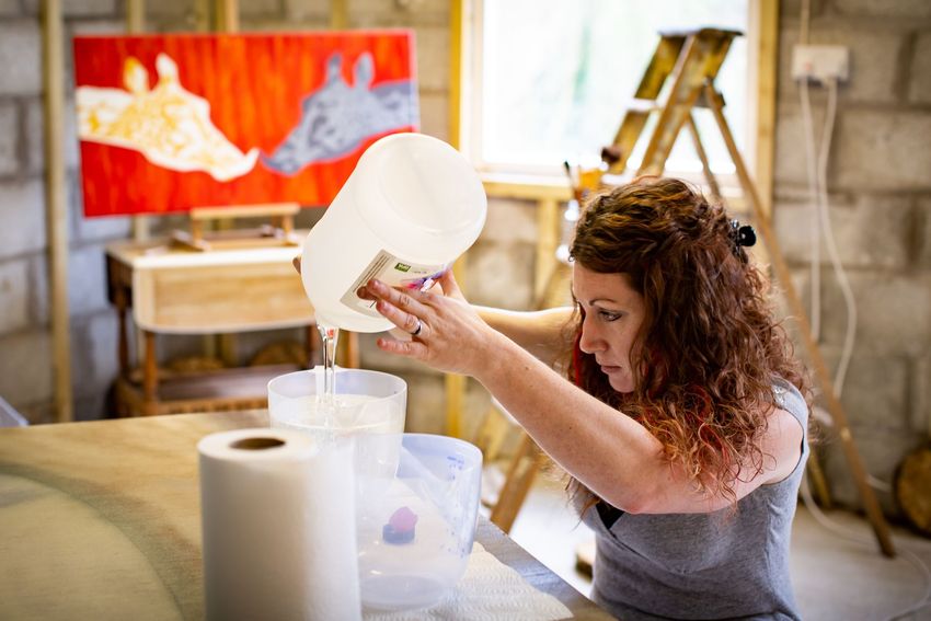 Celia Lancaster pouring resin in her studio