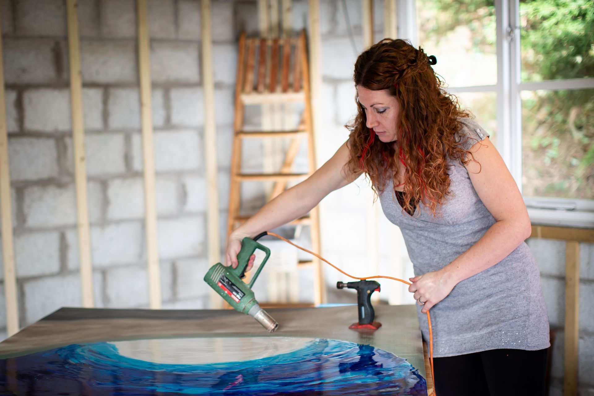 Celia Lancaster working on a resin artwork in her studio