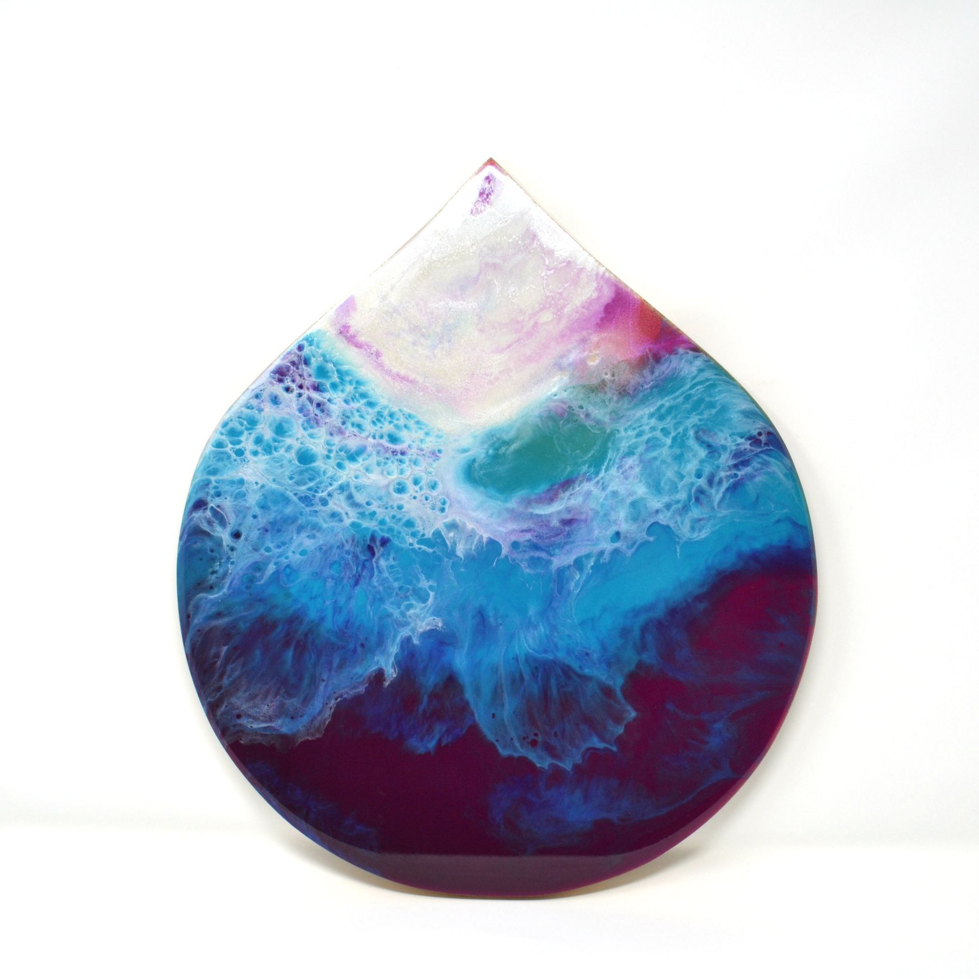 Drop-shaped original resin artwork in turquoise, blue, pink and white tones inspired by water and quiet possibility
