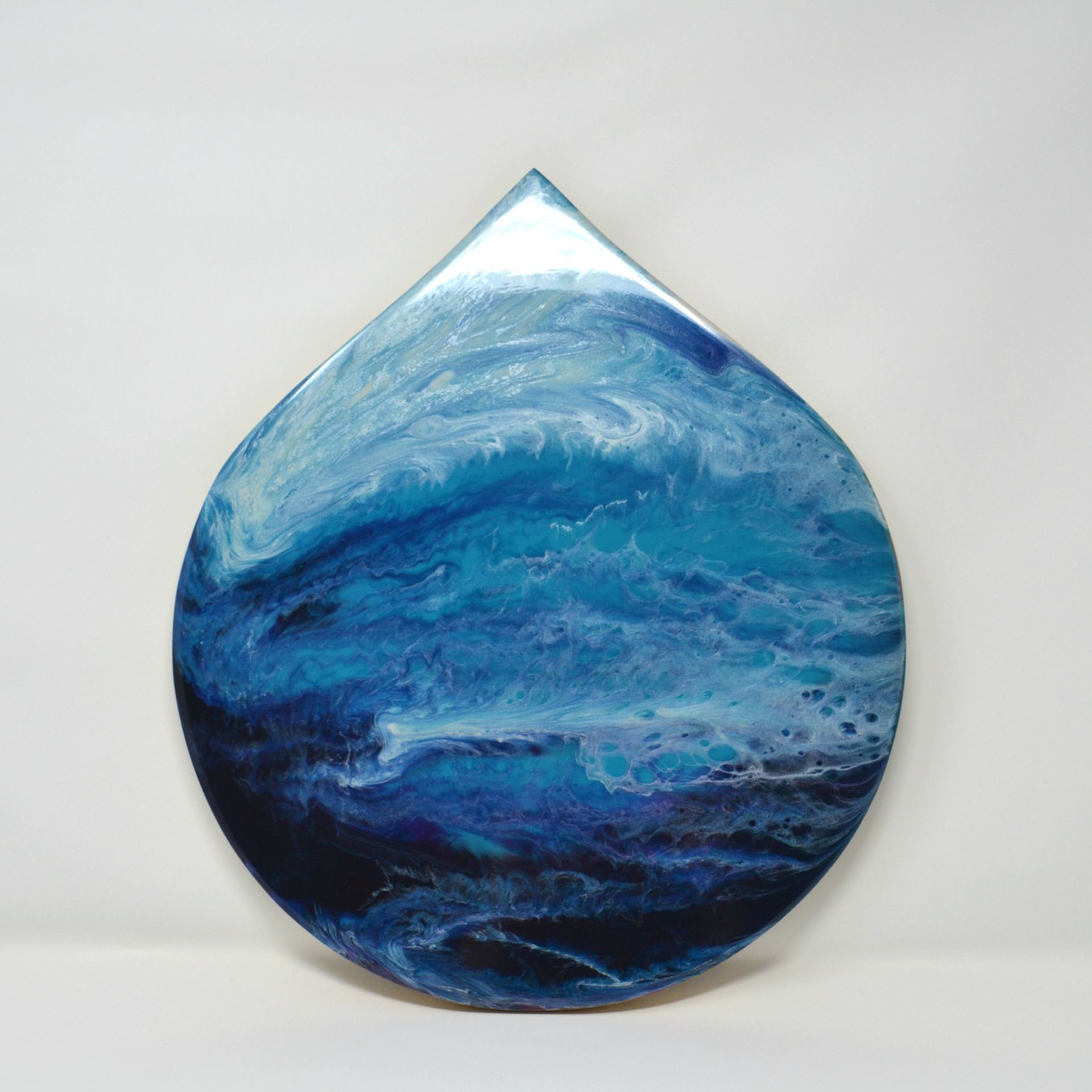 Drop-shaped original resin artwork in flowing blue and white tones inspired by the movement of water