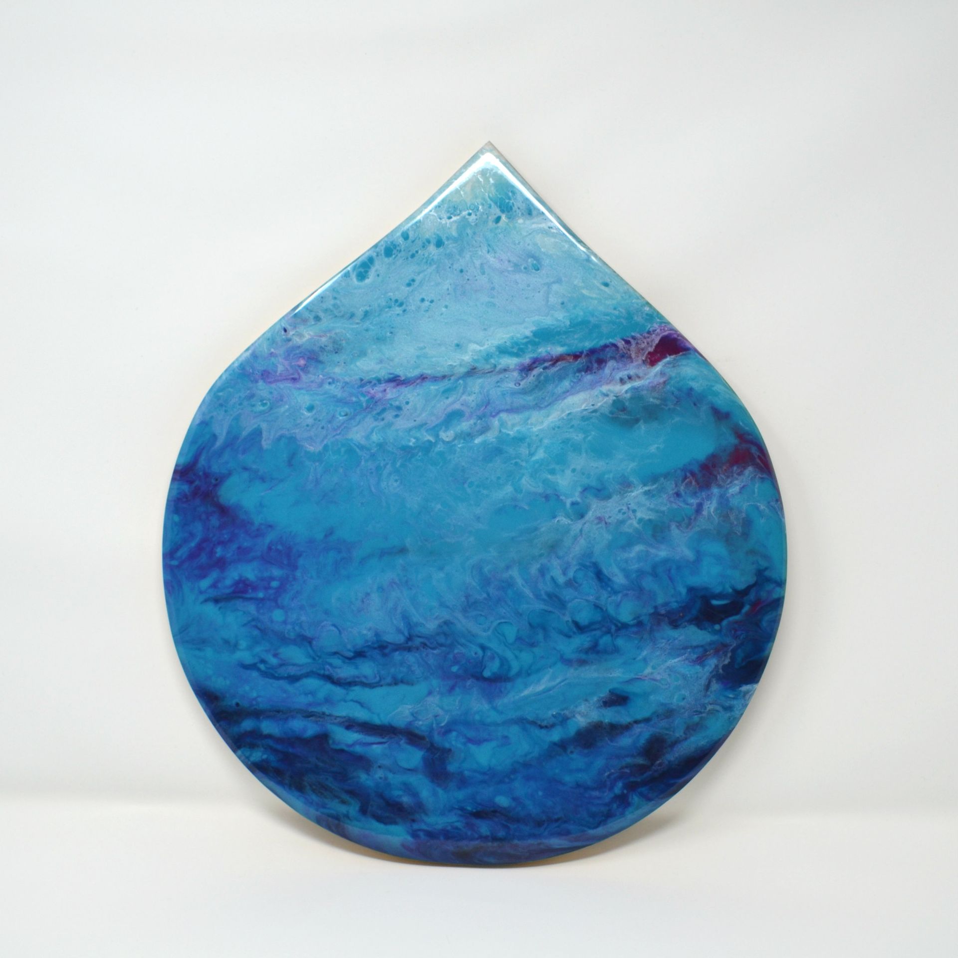 Drop-shaped original resin artwork in layered blue and turquoise tones inspired by water