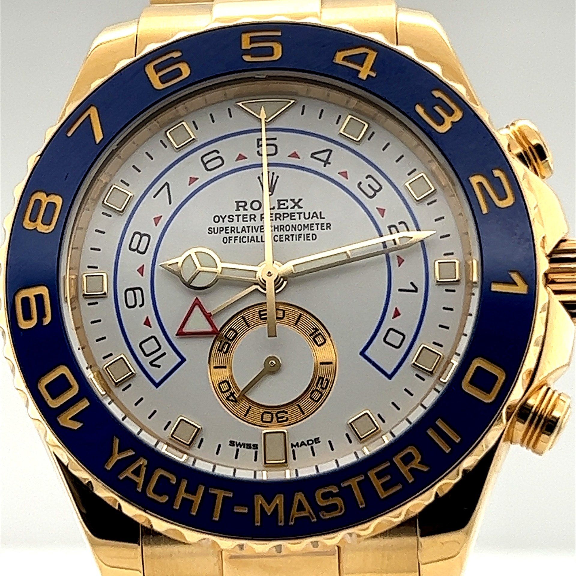 A gold rolex yacht-master ii watch with a blue band