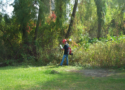 A man is mowing a lush green field in the woods - Baton Rouge, LA - Coastal Environments, Inc. A man is mowing a lush green field in the woods - Baton Rouge, LA - Coastal Environments, Inc.