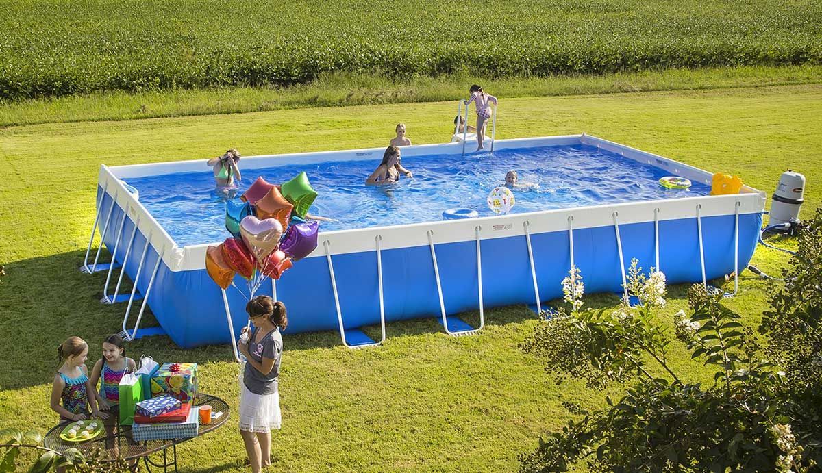 A group of people are playing in a large swimming pool.