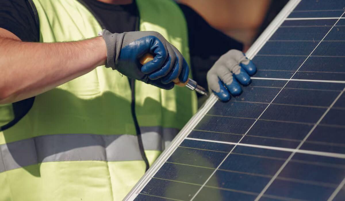 Technician cleaning solar panel
