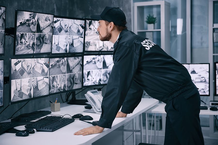 a man standing at a desk in front of a computer