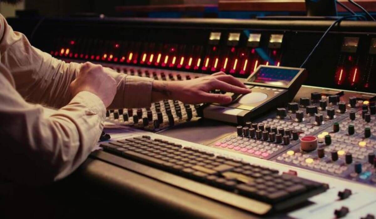 sound technician adjusting mixer