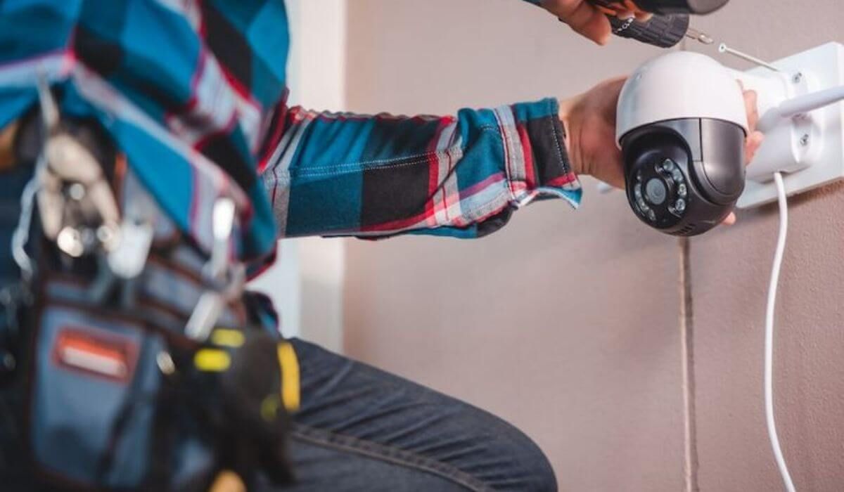 technician installing camera at home
