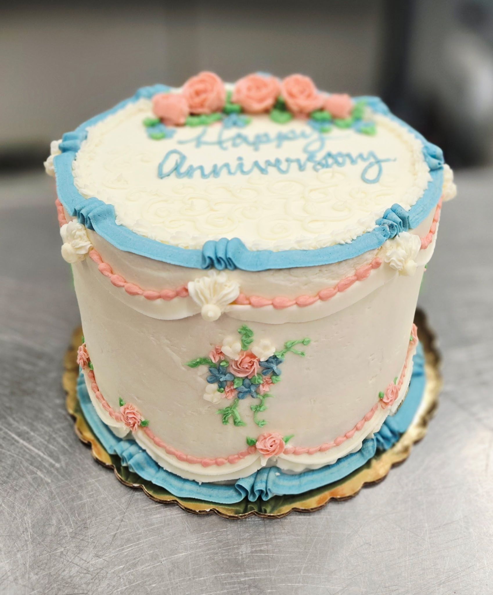 Anniversary cake with blue and pink decorations and