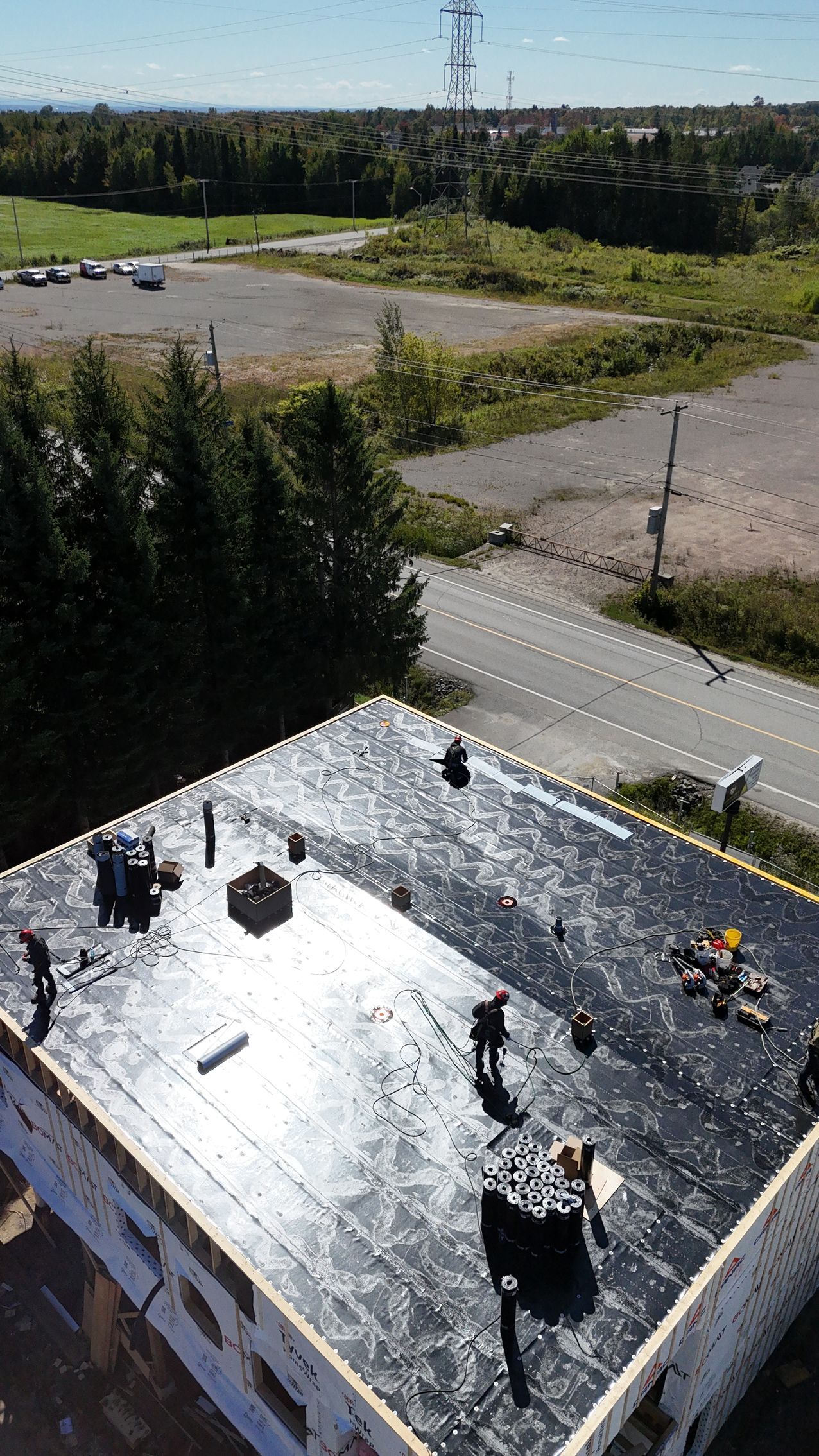 Two men are working on a roof in the snow.