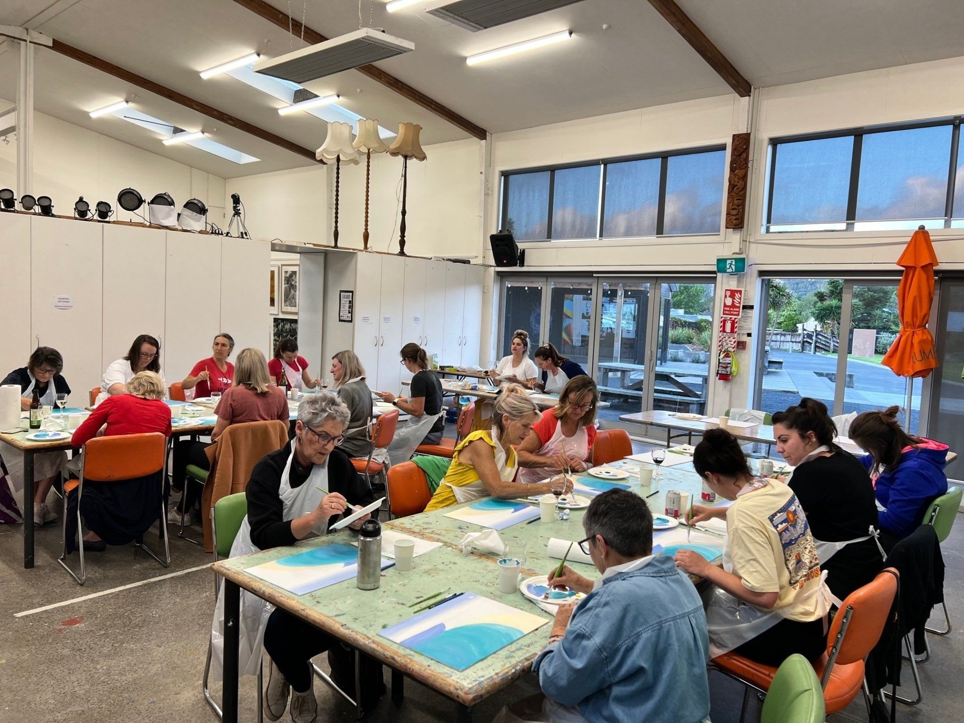 A group of people are sitting at tables in a room.