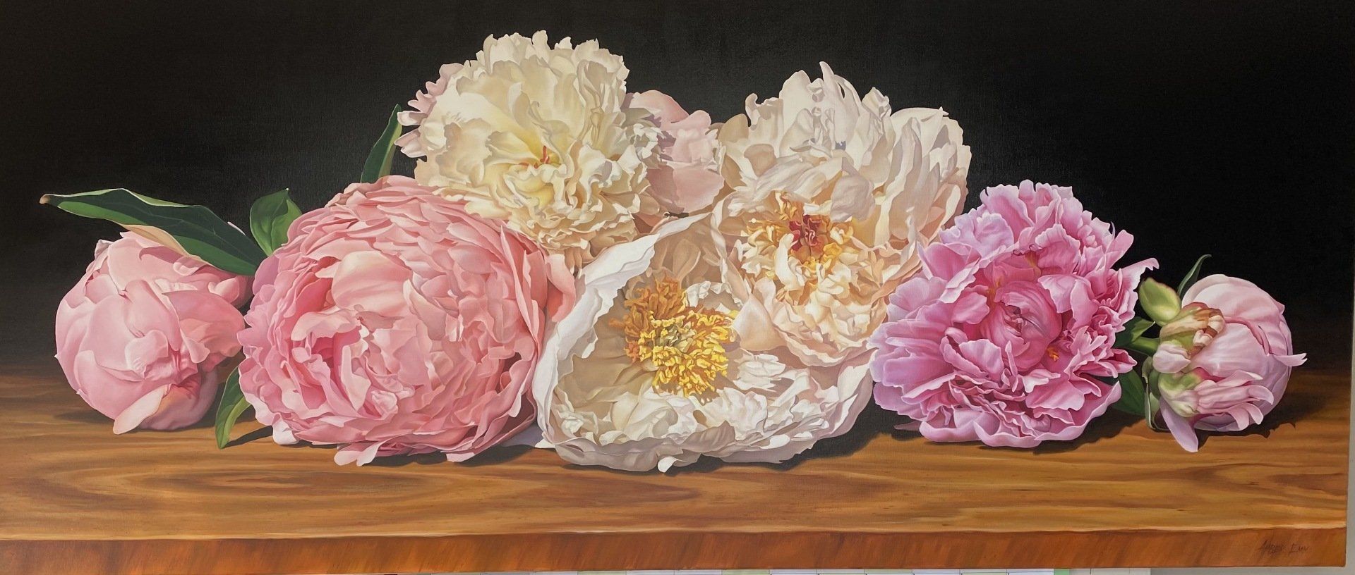 A painting of pink and white flowers on a wooden table